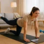 How to Balance Healthy Lifestyle Fitness with a Busy Schedule Young woman exercising at home on a yoga mat while following a fitness routine on her laptop, symbolising healthy lifestyle fitness balance.