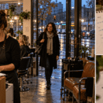 Salon owner reviewing customer appointments and retention records.