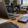 Laptop, smartphone and security key on a small business office desk.