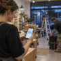 Business owner reviewing an accepted service quote on a smartphone.